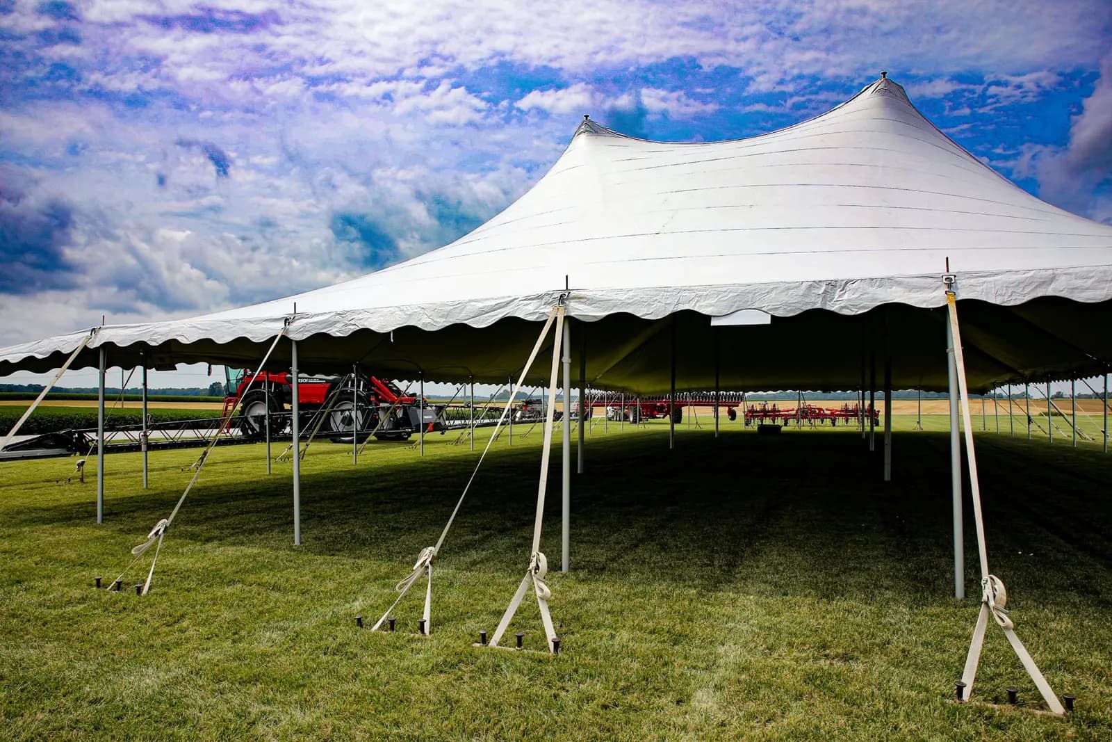 Large white pole tent on grass